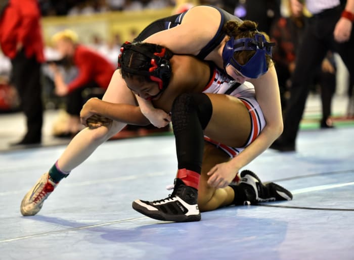 Edmond North's Bella Williams (top) wrestles during the Class 6A girls 140-pound weight class finals on Feb. 24, 2024. Williams got a pin to claim her second straight state title.